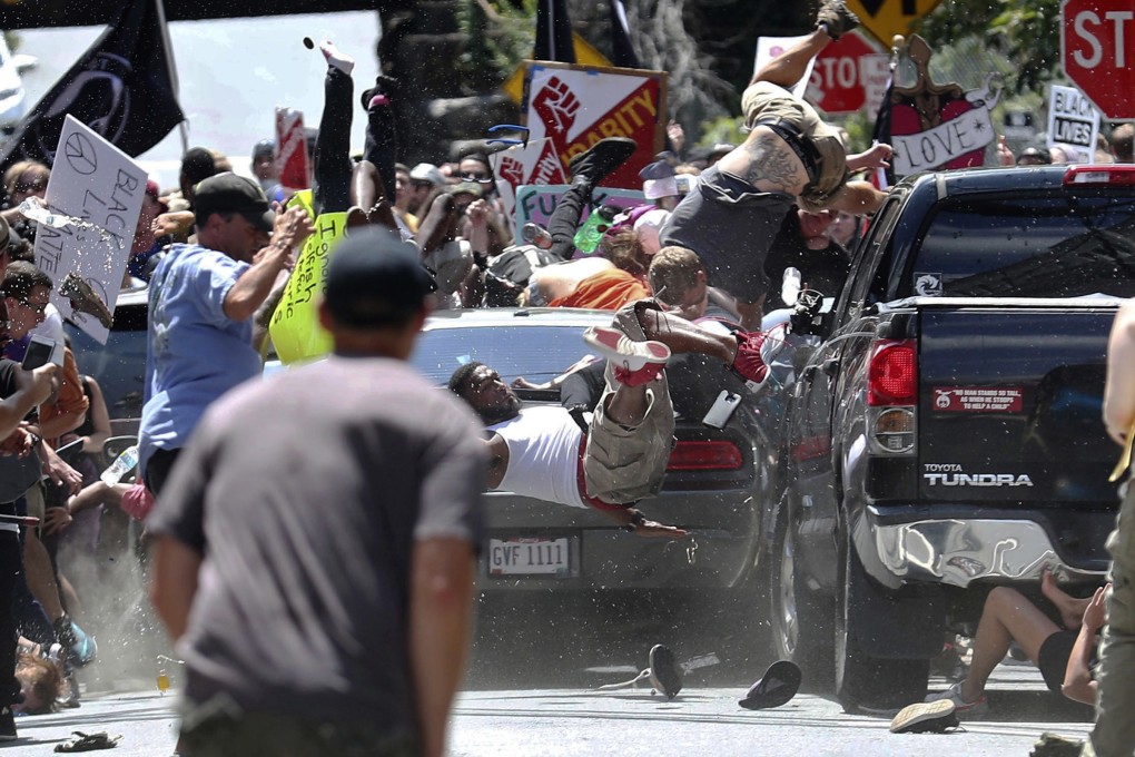 People fly into the air as a vehicle is driven by neo-Nazi James Fields into a group of protesters demonstrating against a white nationalist rally in Charlottesville, Virginia, on August 12, 2017. Photo: AP