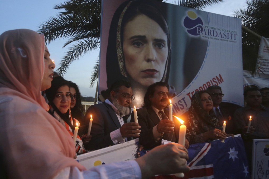A poster of New Zealand Prime Minister Jacinda Ardern in a hijab is the backdrop, as Pakistani civil activists hold a candlelight vigil for the victims of the Christchurch mosque shootings, in Lahore on March 7. At least 50 people were killed and many more injured when a gunman opened fire at two mosques in Christchurch, New Zealand, on March 15. Photo: AP
