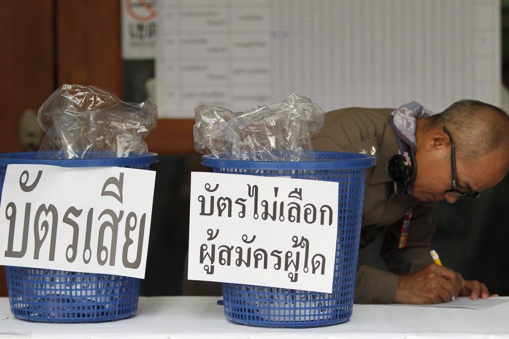 A Thai police officer records results during vote counting in the general election at a polling station in Chiang Mai province on March 24, 2019. Photo: EPA