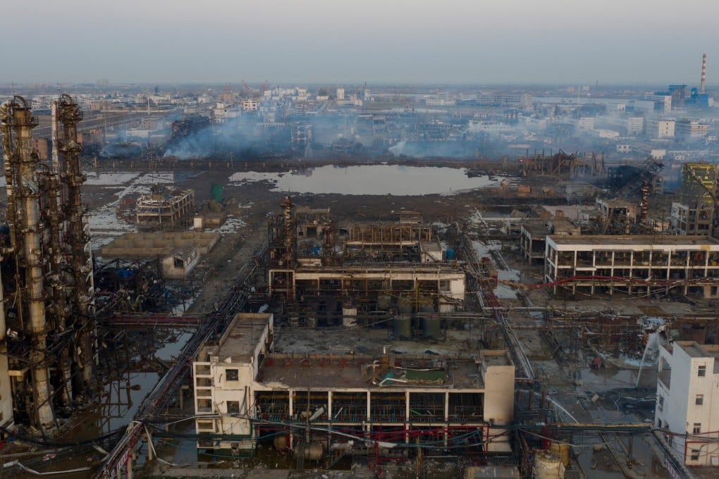 Paramilitary officers have begun backfilling a giant crater at the blast site amid pollution fears. Photo: Reuters