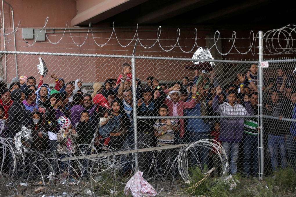 Migrants are held for processing under the Paso del Norte Bridge in El Paso. Photo: Reuters