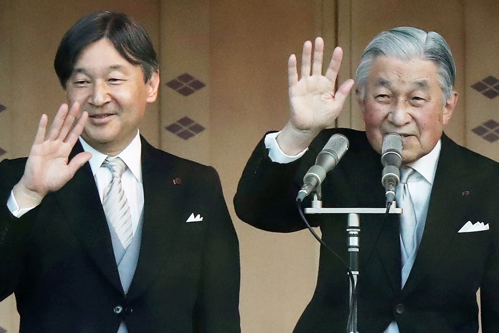 Japan’s Emperor Akihito (right) and Crown Prince Naruhito wave to the crowd at the Imperial Palace in Tokyo on January 2, after the emperor delivered his final New Year’s address. Photo: AFP