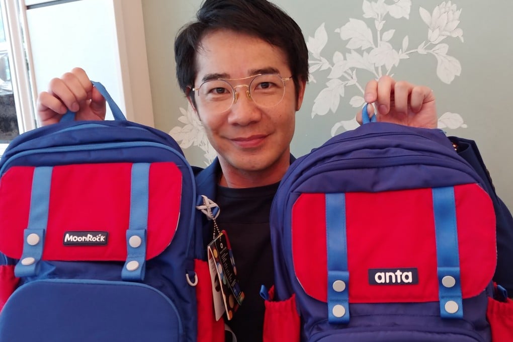 Alvin Ip Tze-fai, chief executive of Grown Up Licenses (Asia), holds the school bag designed by his company under the MoonRock brand and the one made by Anta. Photo: Enoch Yiu