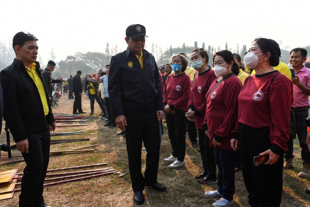 Thailand’s Prime Minister Prayuth Chan-ocha speaks to volunteers about combating pollution while visiting an army base in Chiang Mai. Photo: AFP