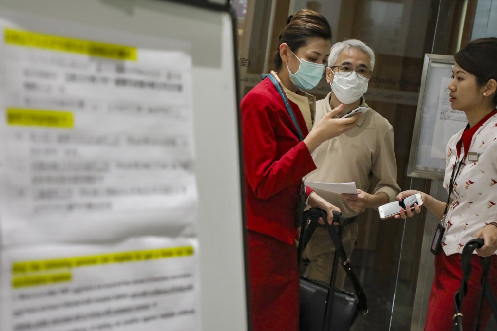 Airport workers queue for the measles vaccination on Monday. Some airport employees complained of confusion over the vaccination campaign set up by the Centre of Health Protection. Photo: Felix Wong