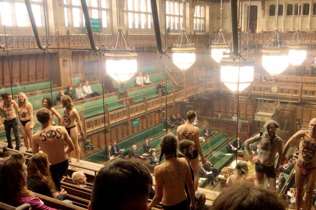 A handout photo made available by UK Extinction Rebellion shows seminude activists in the public gallery of the UK Parliament during votes on Brexit on Monday. Photo: EPA