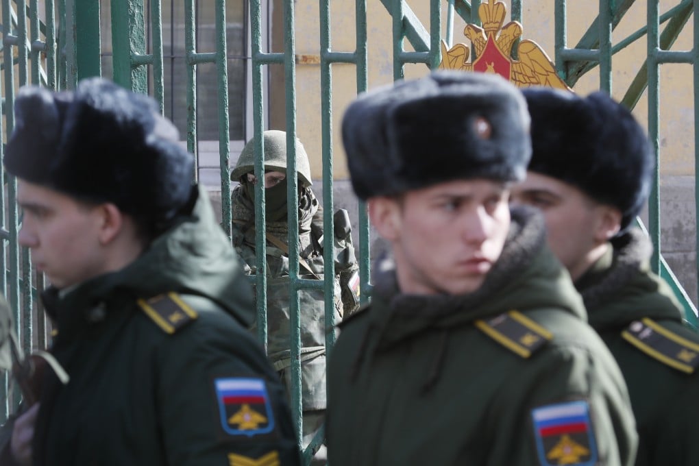 A soldier guards an entrance while cadets leave the Alexander Mozhaisky Military Space Academy in St Petersburg, Russia on April 2, 2019. Photo: AP