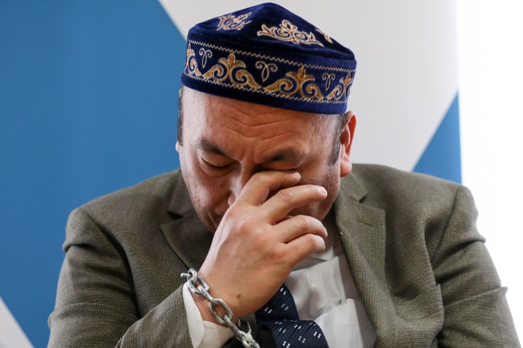 Former camp prisoner Omer Bekali wears chains and is overcome by emotion as he talks about re-education camps in Xinjiang, during a news conference of the World Congress of the Uygurs and the Society for Threatened Peoples, on March 11 in Berlin. Photo: EPA-EFE