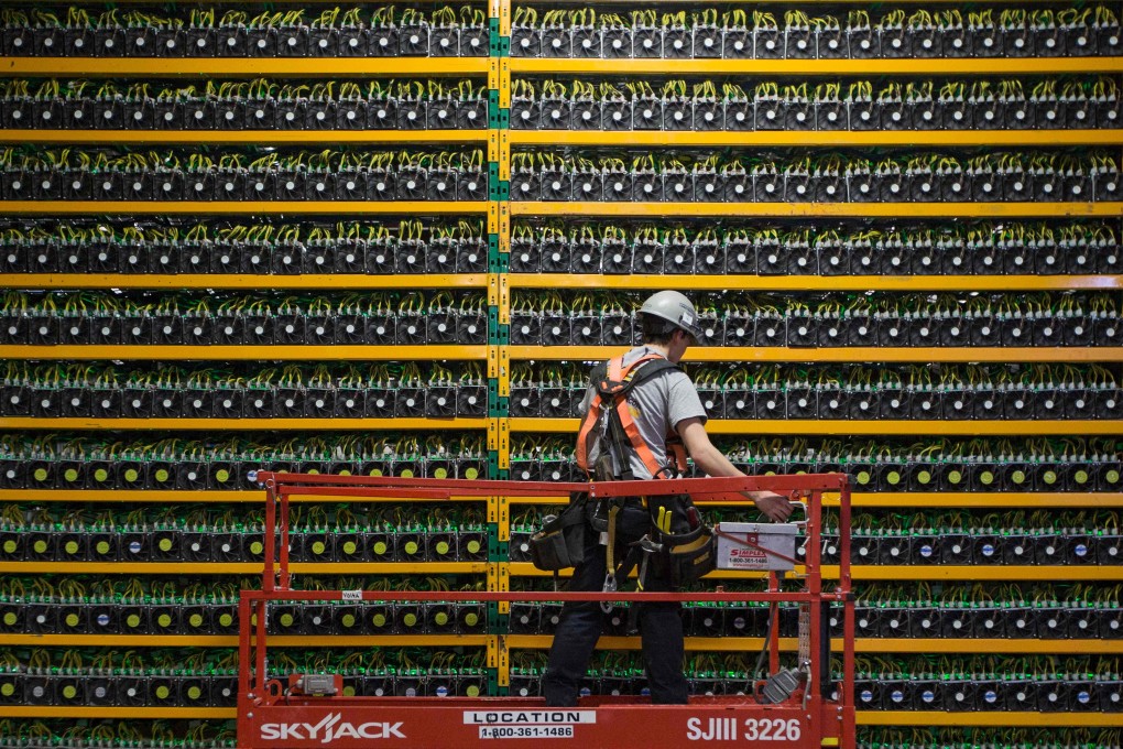 A technician inspects bitcoin mining machines at a cryptocurrency farming operation, Bitfarms, in Quebec. Blockchain is the decentralised database technology that underpins bitcoin and other digital currencies. Photo: AFP