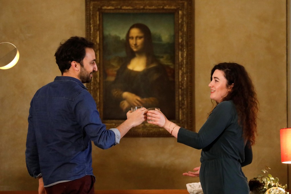 Airbnb employees posing in front of the Mona Lisa by Leonardo da Vinci during a rehearsal for the contest announced today. Photo: Reuters