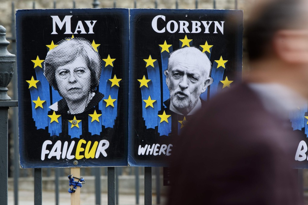 Placards featuring Britain's Prime Minister Theresa May and opposition Labour Party leader Jeremy Corbyn could be seen near the Houses of Parliament in central London on Wednesday Photo: AFP