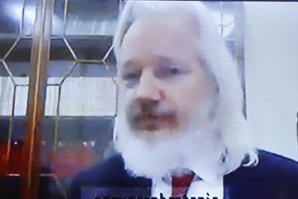 Julian Assange sports long hair and a beard in a December video conference. Photo: AFP