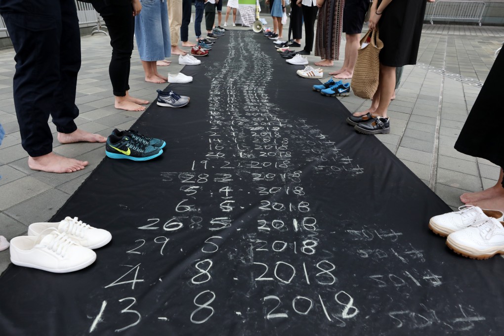Dates written in chalk and trainers mark the lives cut short in Hong Kong, as demonstrators appeal for more government support on World Suicide Prevention Day, in Admiralty on September 10, 2018. Photo: Dickson Lee