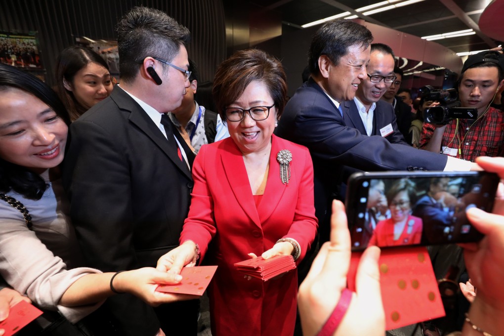 Hong Kong Exchanges and Clearing chair Laura Cha and HKEX chief executive Charles Li give out red packets on the first trading day of the new lunar year on February 8. Photo: Felix Wong