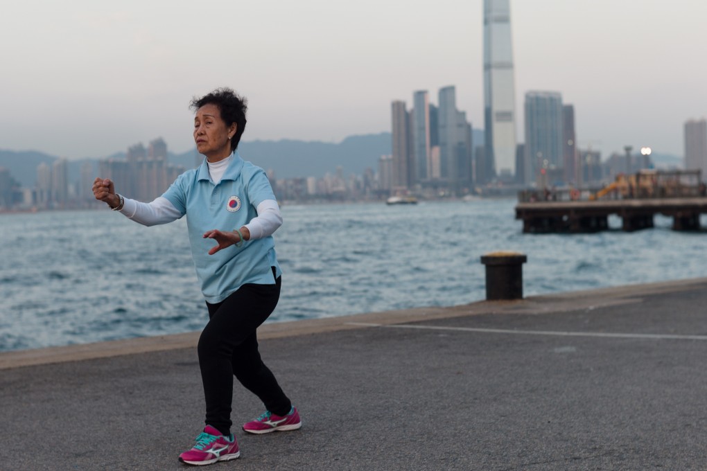 An elderly woman practises tai chi on a pier facing Victoria Harbour in February. Photo: EPA-EFE