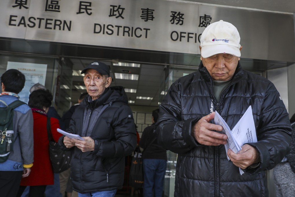 People queue for application forms for the handout scheme in Sai Wan Ho. Photo: Sam Tsang