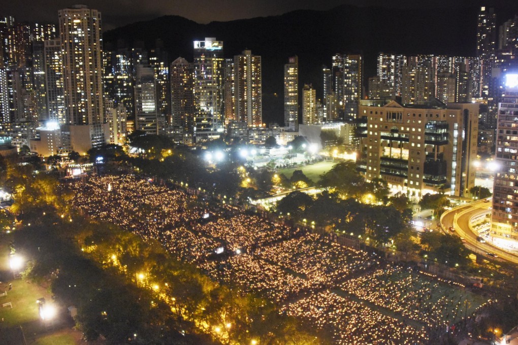 People hold candles in Hong Kong’s Victoria Park on June 4, 2018, to mark the 29th anniversary of the 1989 crackdown in Tiananmen Square. Photo: Kyodo