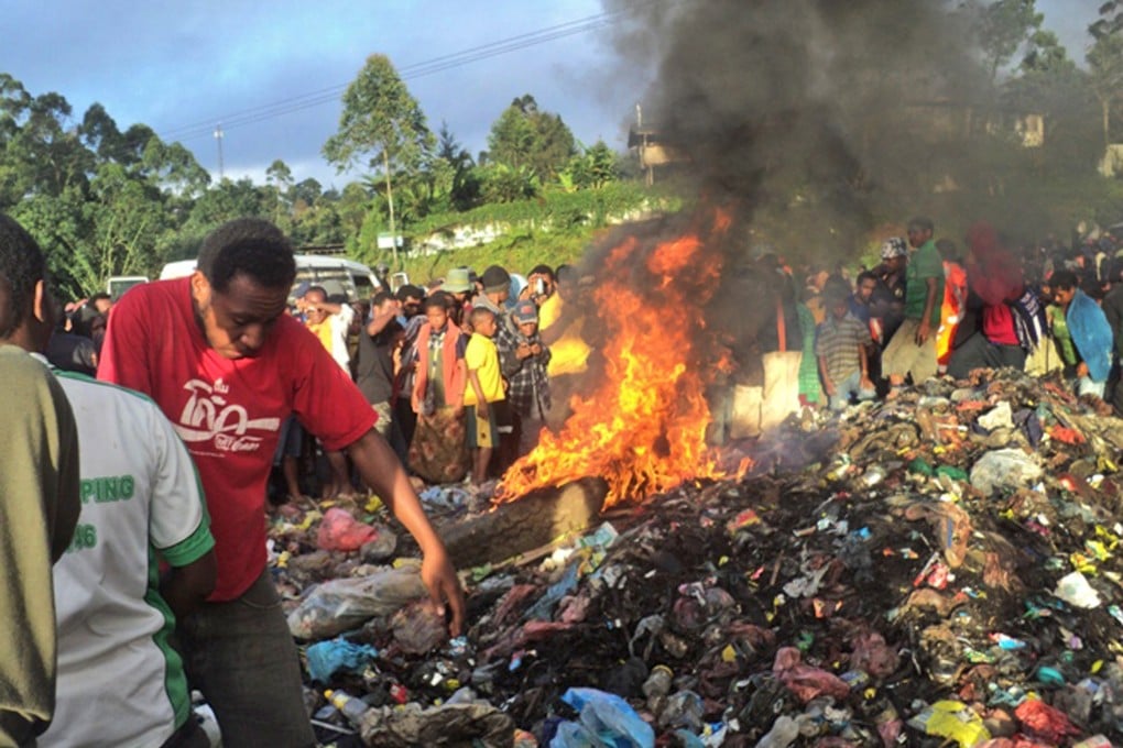 Purported to be the burning rubbish pile on Warakum Junction Road, in Mount Hagen, Papua New Guinea, on to which 20-year-old Kepari Leniata was thrown in 2013. Photo: AFP