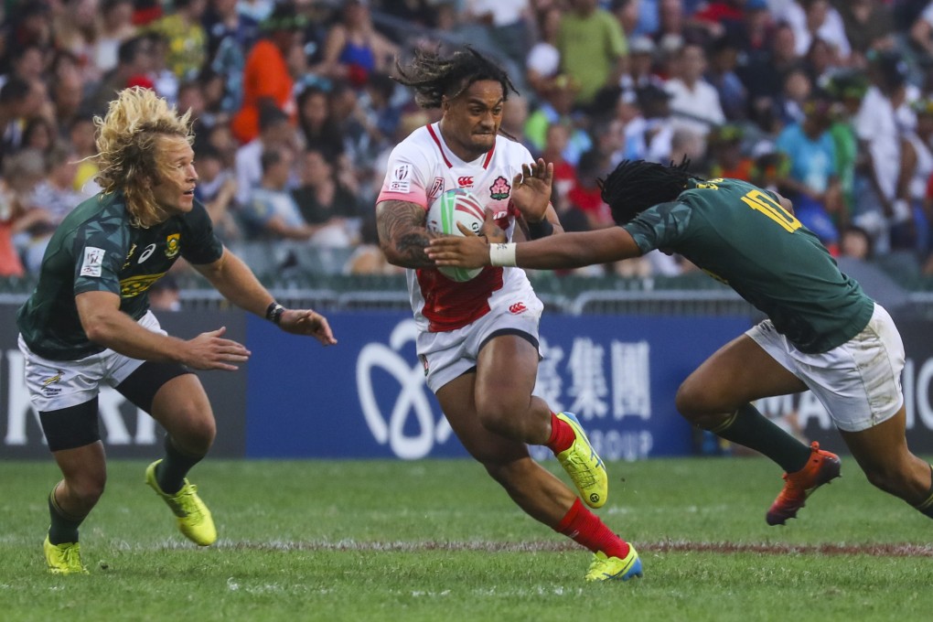 Japan’s Siosifa Lisala runs away from South Africa’s Werner Kok and Stedman Gans. Photo: Edmond So