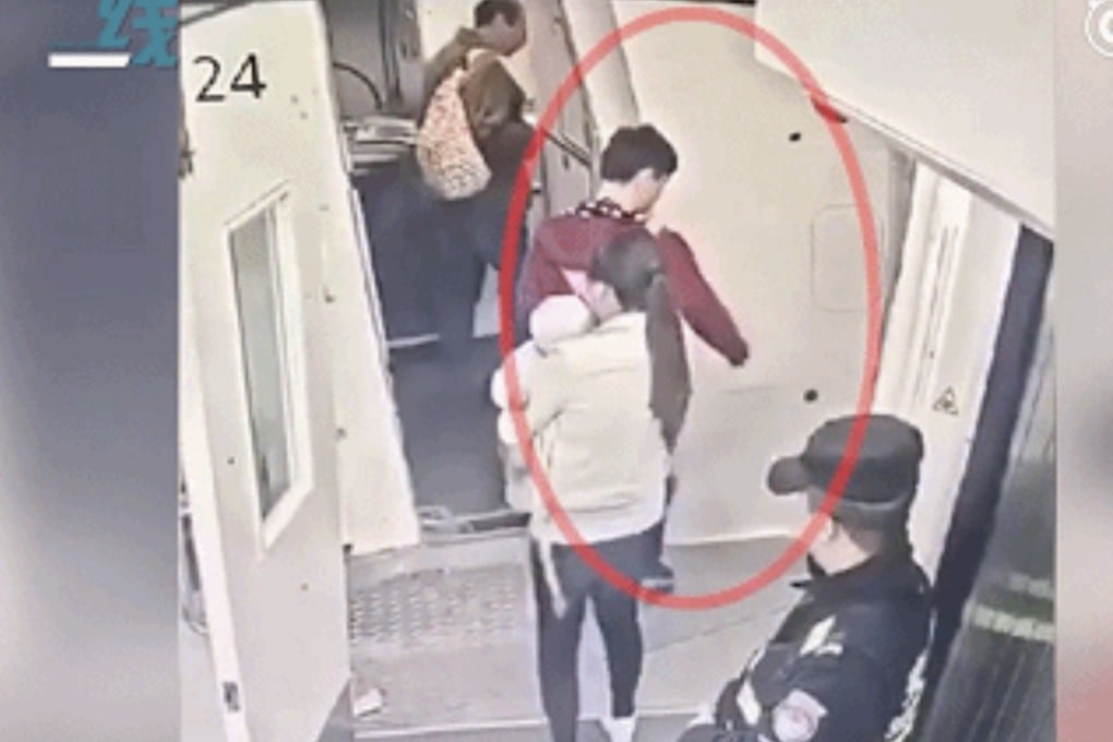 A man from central China is seen making a throwing motion as he and his wife and child board a flight from Wuhan in Hubei province to Xinjiang on Tuesday. Photo: Miaopai