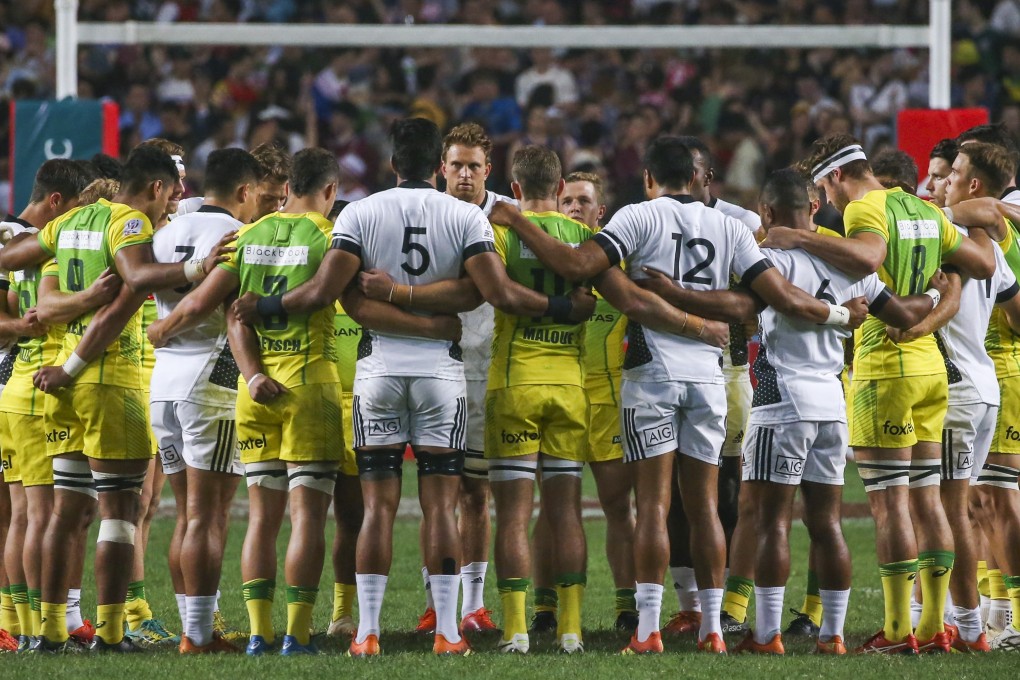 New Zealand and Australia embrace in memory of the Christchurch shooting victims before playing their opening match of the Hong Kong Sevens. Photo: Felix Wong