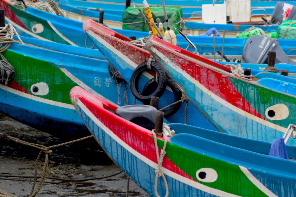 Traditional Taiwanese fishing boats are seen at low tide in Bali district, New Taipei City, on March 3, 2019. (Photo by Sam Yeh / AFP)