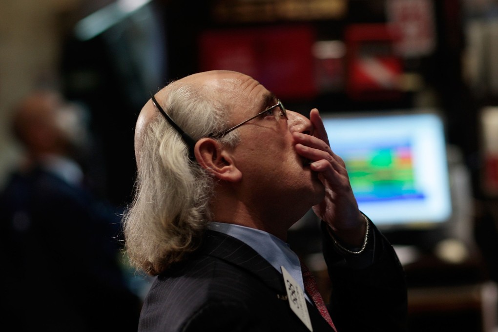 A financial professional reacts to market volatility on the floor of the New York Stock Exchange on March 6, 2009. Photo: AFP