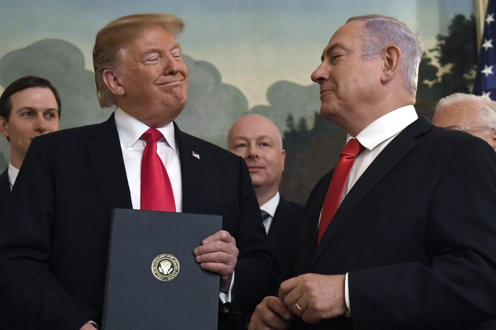 US President Donald Trump smiles at Israeli Prime Minister Benjamin Netanyahu after signing a proclamation in the Diplomatic Reception Room at the White House in Washington on March 25. Photo: AP