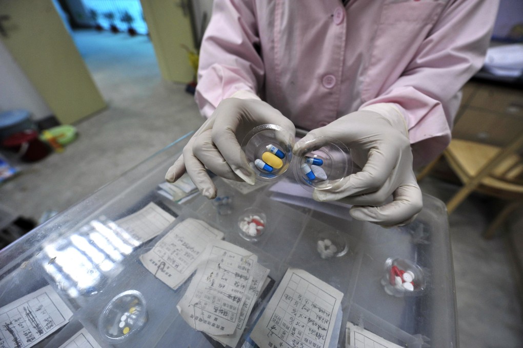 A nurse with a cocktail of drugs for Aids patients at a hospital in Chongqing on November 30, 2008. Combination therapy- the use of two or more drugs to cure a disease - is increasingly being applied in oncology in the medical industry’s quest to fight cancer. Photo: AFP
