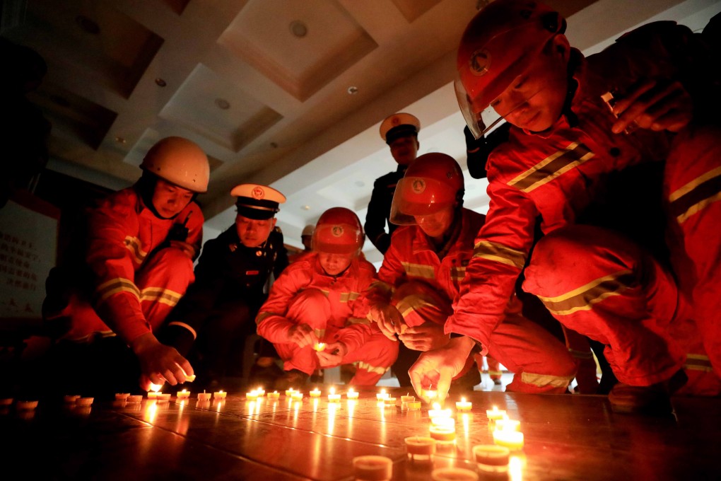 Firefighters light candles during a vigil for the colleagues they lost in a huge blaze in Sichuan province. Photo: EPA-EFE