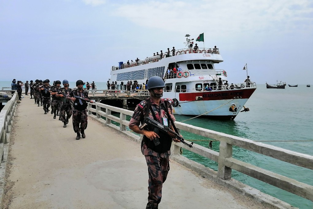 Border Guards Bangladesh (BGB) paramilitary personnel disembark on Saint Martin’s island in the Bay of Bengal on Sunday. This is the first time they have been deployed to an island near its southern border with Myanmar in 20 years, officials said. Photo: STR via AFP