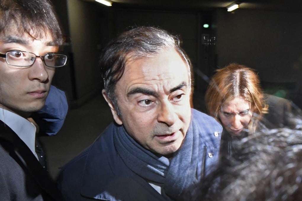 In this Wednesday, April 3, 2019, file photo, former Nissan Chairman Carlos Ghosn, centre, leaves his lawyer's office in Tokyo. Tokyo prosecutors arrested Ghosn on Thursday, April 4, 2019 for a fourth time on fresh allegations that cut short his brief time outside detention. (Sadayuki Goto/Kyodo News via AP, File)