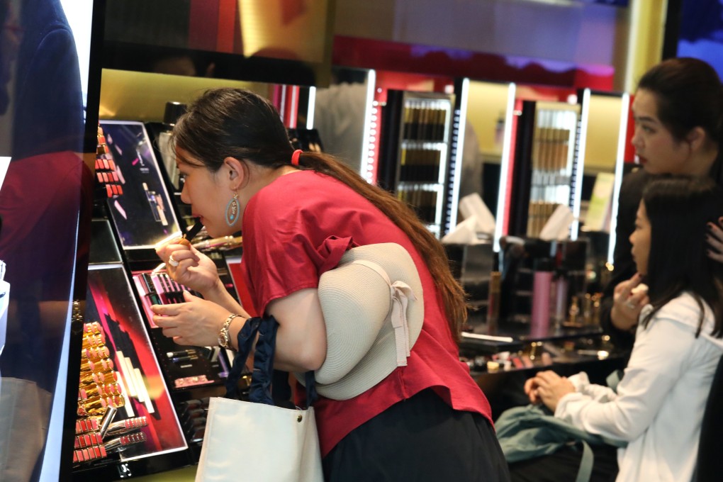 Mainland Chinese tourists look at goods at the Elements shopping centre in West Kowloon. Tourists bringing personal items back to China from Hong Kong will face lower taxes. Photo: Nora Tam