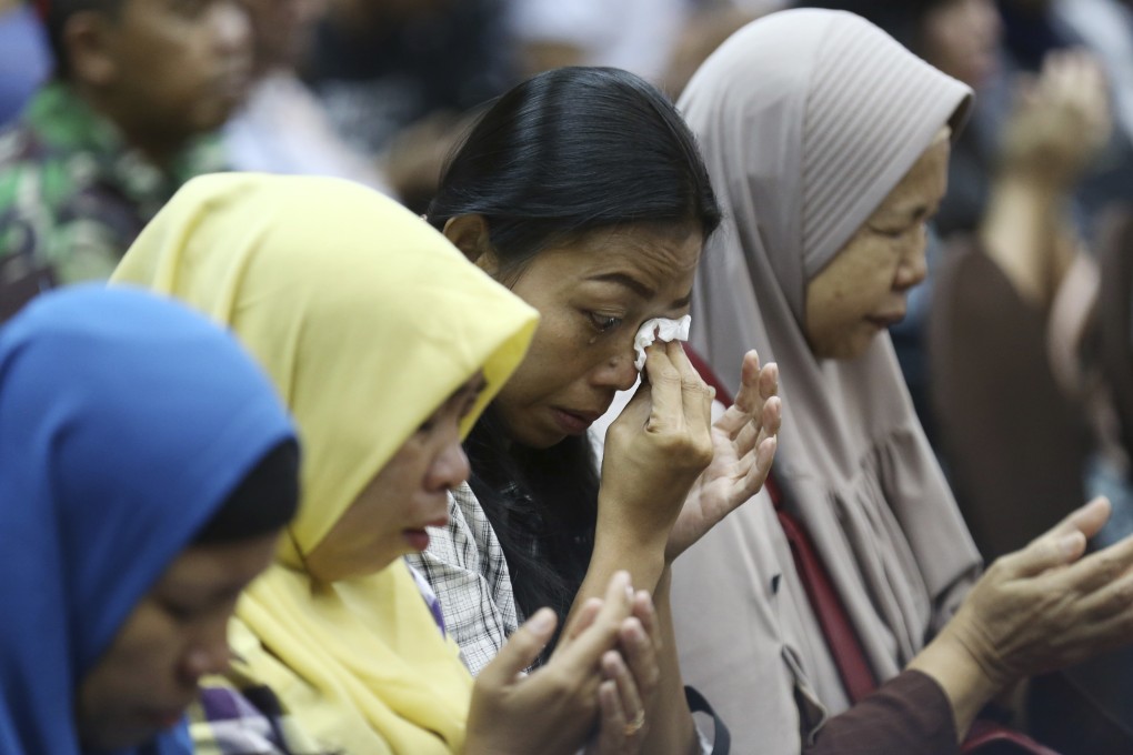 Relatives weep as they pray for victims of the Lion Air jet that crashed into the Java Sea. Photo: AP