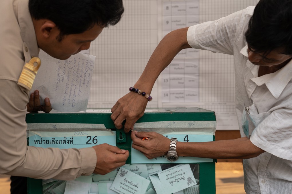 Thai officials open a sealed ballot box ahead of counting. Photo: Bloomberg