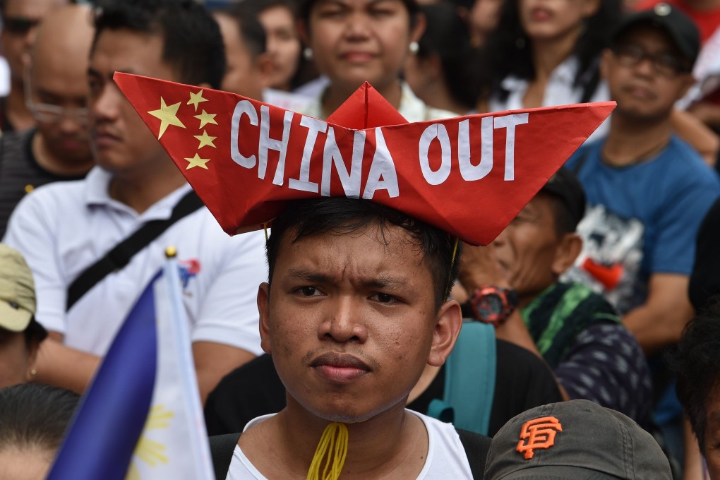 Protesters march in front of the Chinese consular office in Manila. Photo: AFP