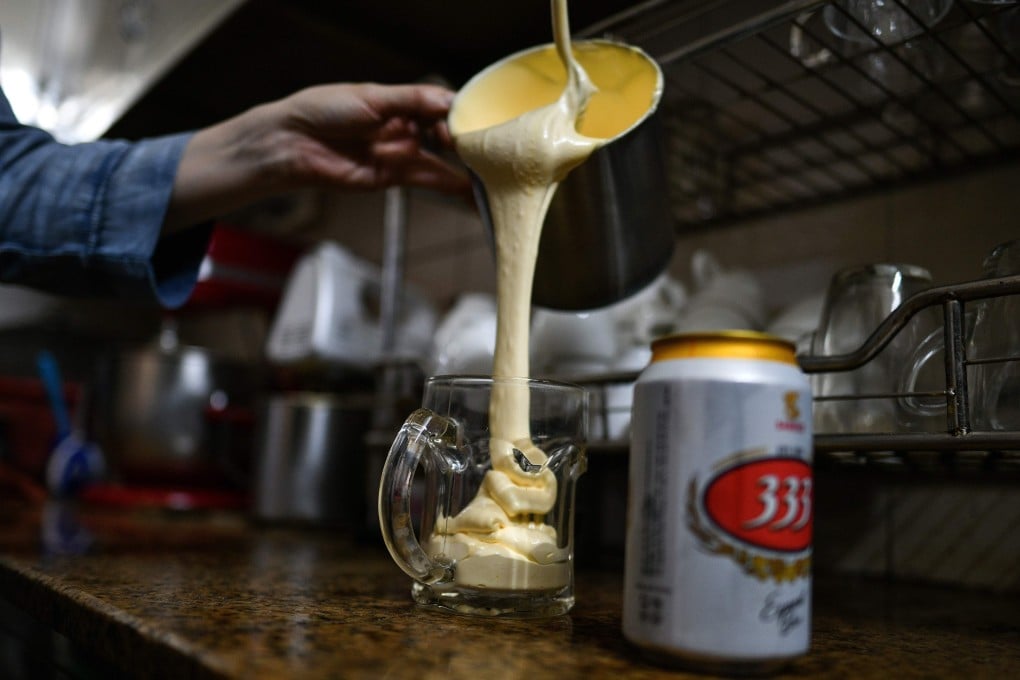 Nguyen Giang pours a sweetened egg mixture into a beer glass at the decades-old Giang Cafe in Hanoi. Photo: AFP