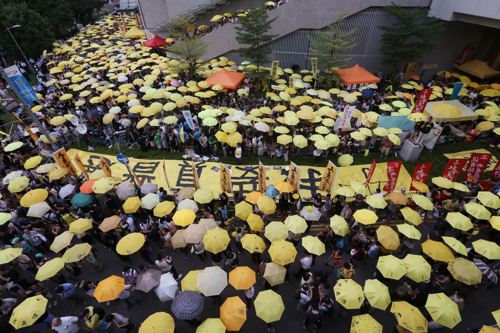 Pro-democracy protesters holding symbolic yellow umbrellas gather outside the government headquarters in Admiralty to mark the first anniversary of Occupy Central, on September 28, 2015. Photo: Dickson Lee