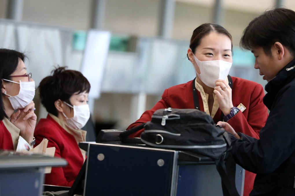 Cathay Pacific ground staff wear face masks at check-in counters at the Hong Kong International Airport on March 24, in the early days of the measles outbreak. Pregnant Cathay flight attendants a few days later threatened to go on mass sick leave unless the airline improved its safeguards. Photo: Nora Tam