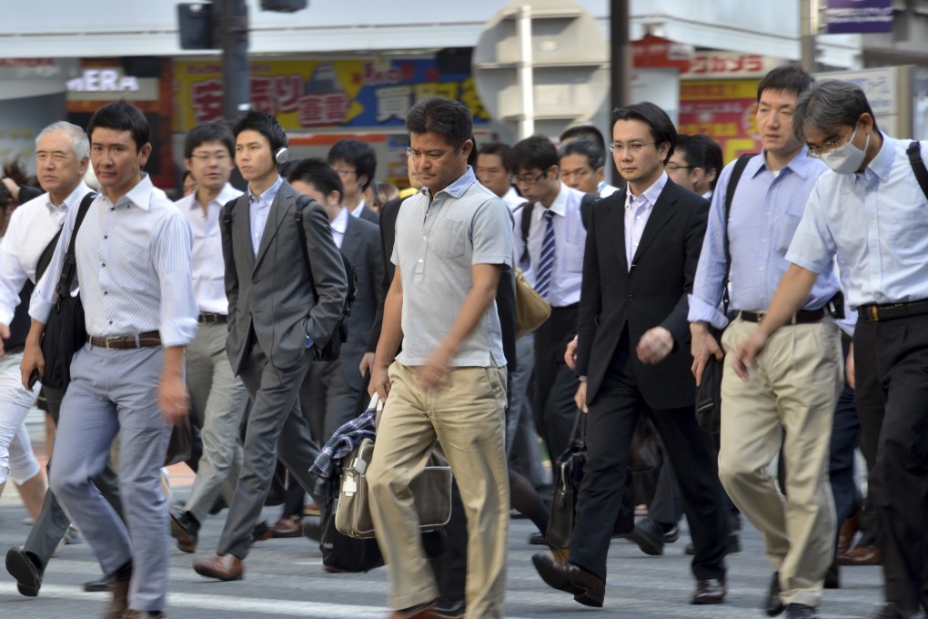 Japanese businessmen heading to their offices in Tokyo. A gang of Chinese thieves targeted sleeping Japanese salarymen in a spate of hotel robberies. Photo: AFP