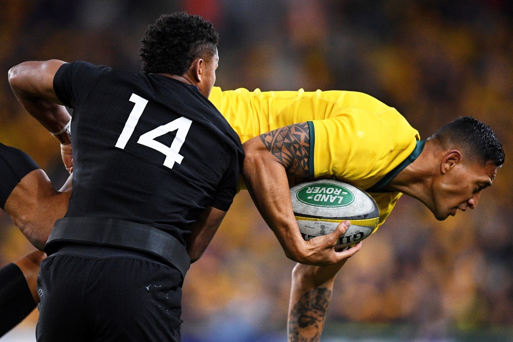 Israel Folau is tackled by Waisake Naholo. He has had his contract terminated by Rugby Australia. Photo: EPA