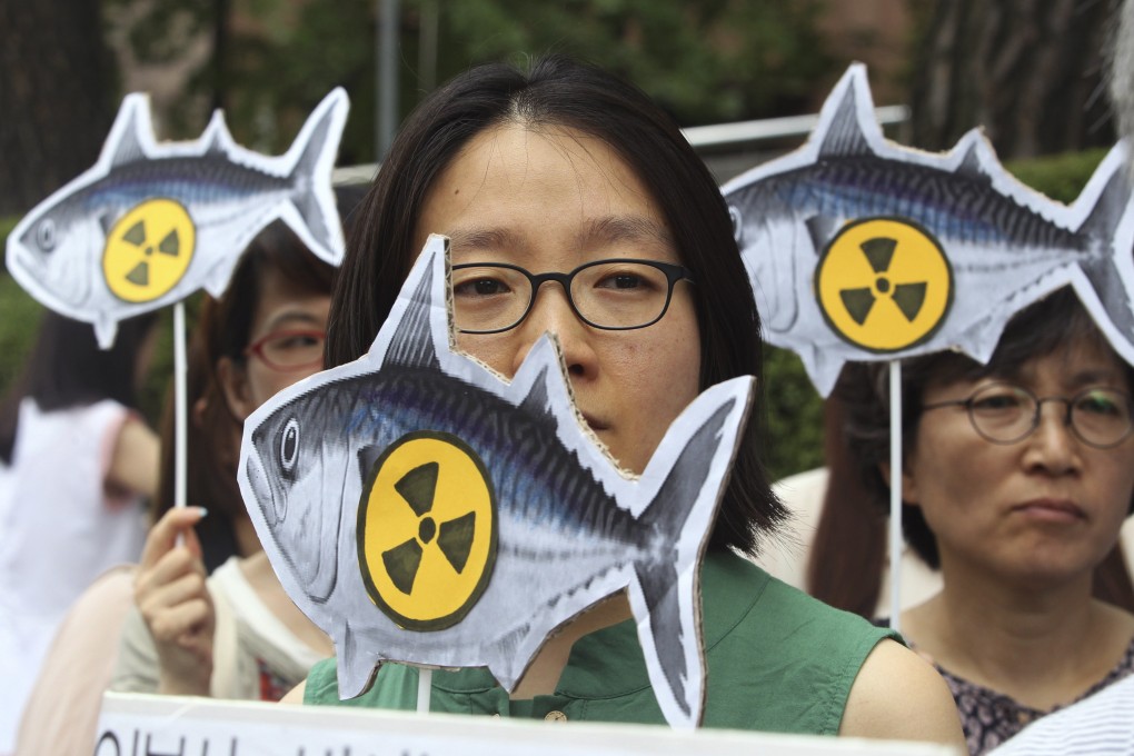 Environmentalists stage a rally denouncing imported agricultural and marine products from Japan. Photo: AP