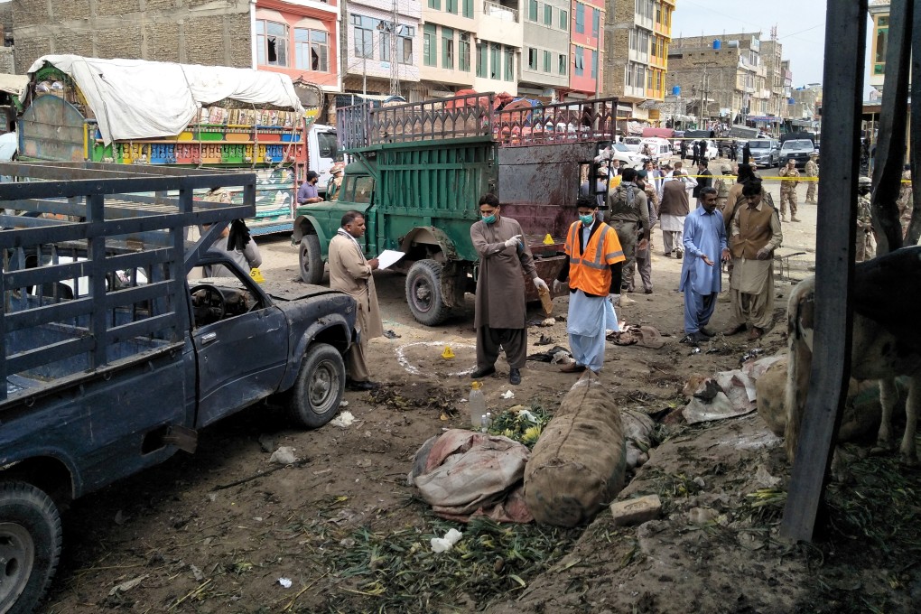 Members of the bomb disposal unit survey the site after a blast at a vegetable market in Quetta. Photo: Reuters