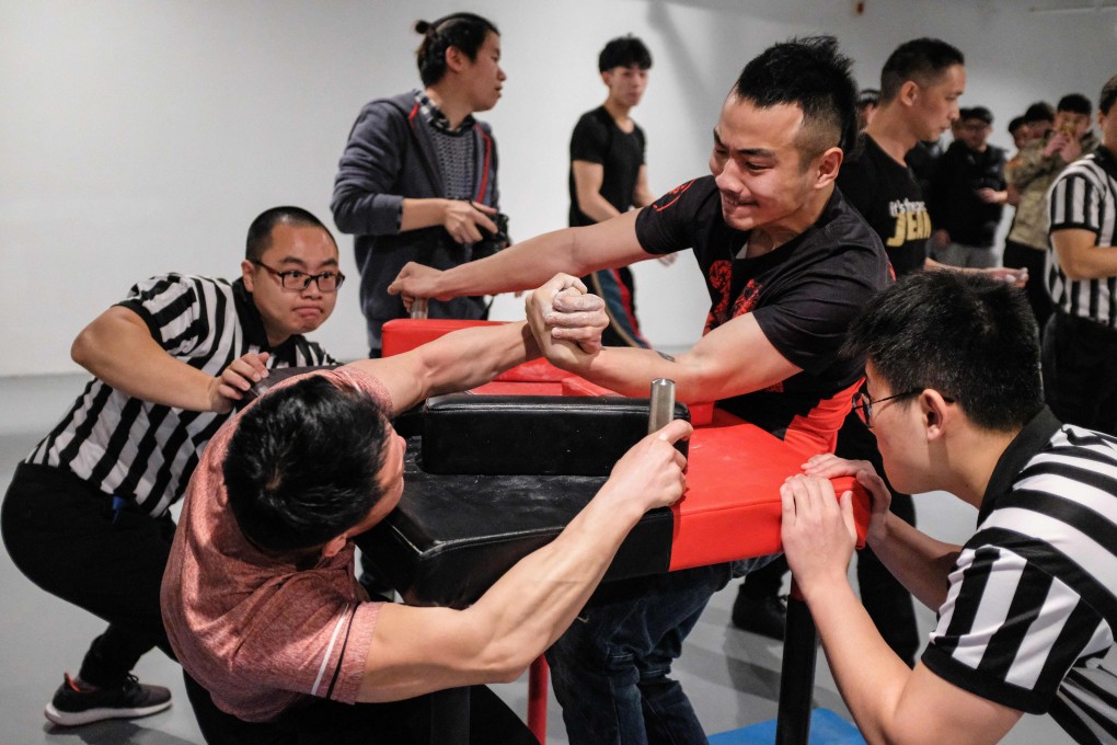 Participants competing in the 7th Shanghai Arm Wrestling Open in Shanghai. Photo: AFP