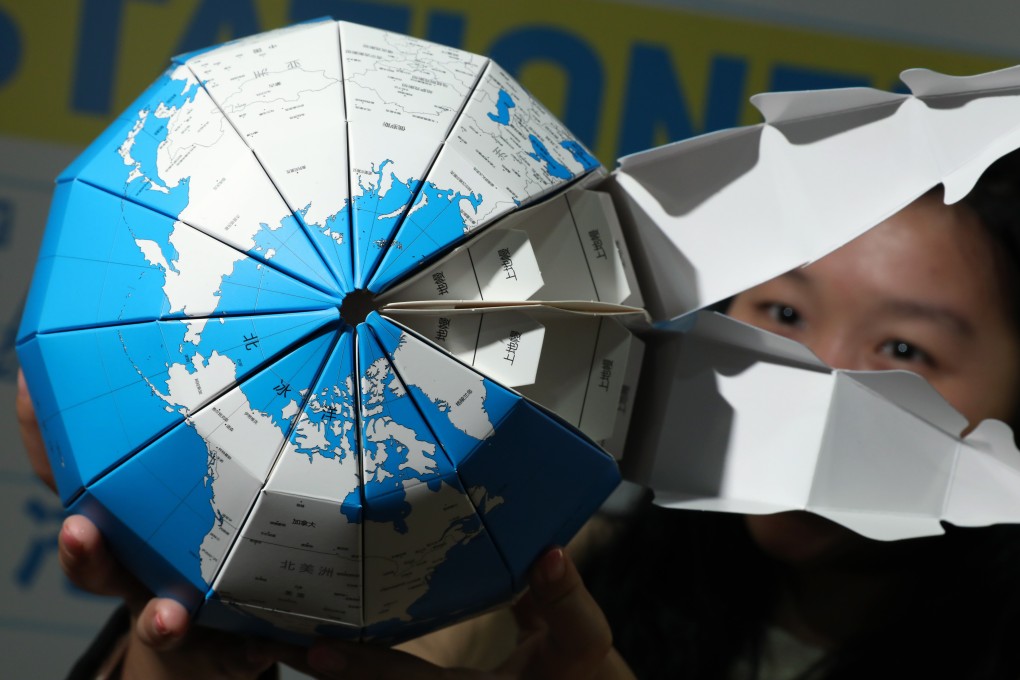 A representative of Shangdong Orange Paper Import and Export Company introduces its paper globe at a trade fair in Hong Kong in January. The “China model” of development has come under attack recently for being insufficiently open to foreign companies. Photo: Nora Tam
