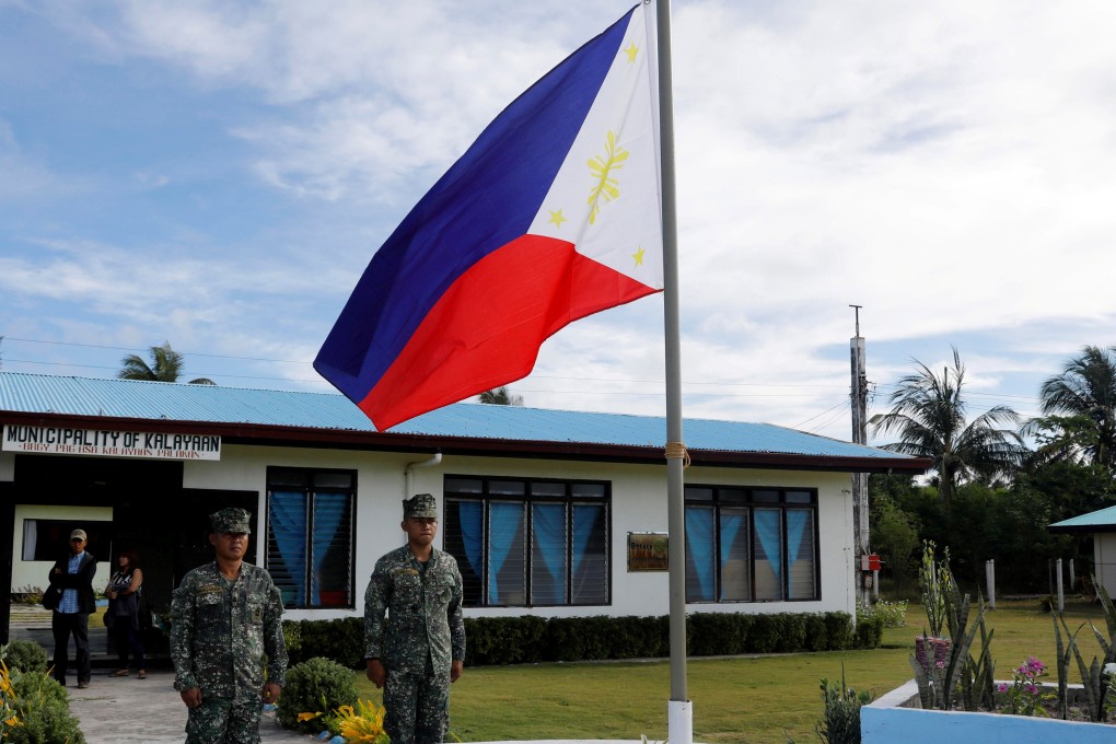 Filipino soldiers stand at attention on Thitu Island in the South China Sea. Photo: Reuters