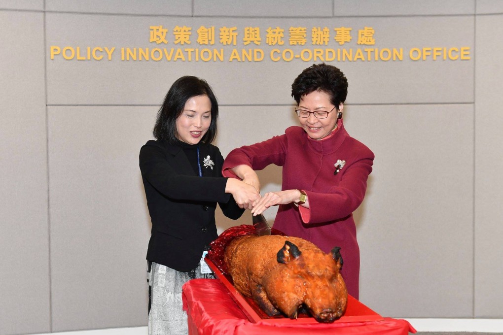 Chief Executive Carrie Lam (right) and Betty Fung, director of the Policy Innovation and Coordination Office cutting a roast pig to mark the opening of the office in December 2018. Photo: Facebook