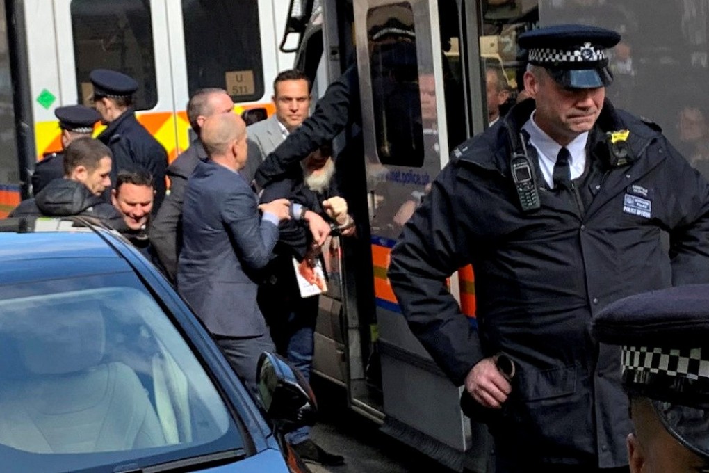 WikiLeaks founder Julian Assange being handled by Metropolitan Police officers during his arrest outside the Ecuador embassy in London on April 11, 2019. Photo: Adrian Cotterill/Daily Dooh/Reuters