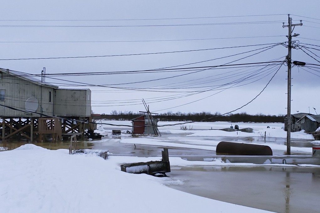 High water pushed up the Yukon River from the Bering Sea floods gardens around homes in the western village of Kotlik, Alaska, in February. Warm winds had melted or pushed away Bering Sea ice, leaving coastal villages vulnerable to winter flooding. Philomena Keys via AP
