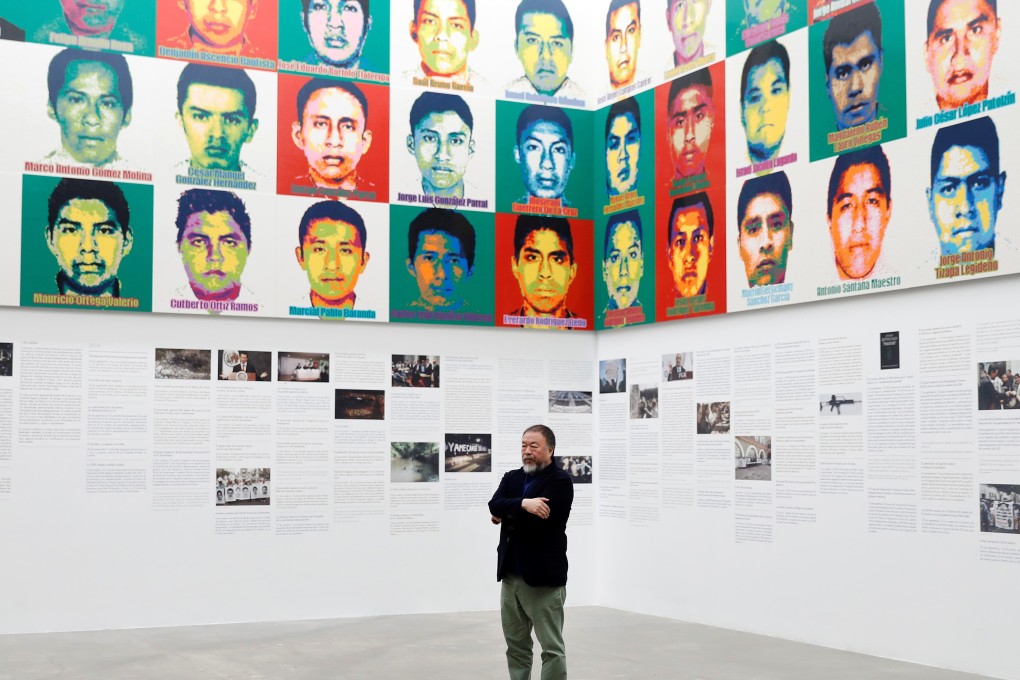 Chinese artist Ai Weiwei in front of portraits of the 43 missing Ayotzinapa College Raul Isidro Burgos students. Photo: Reuters